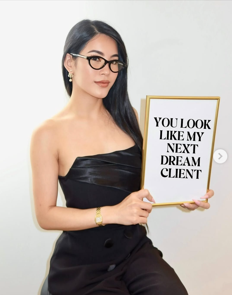 Scarlett Nguyen holding a sign reading 'You look like my next dream client'